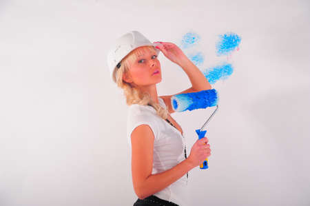 Rear view of a woman painting the wallの写真素材