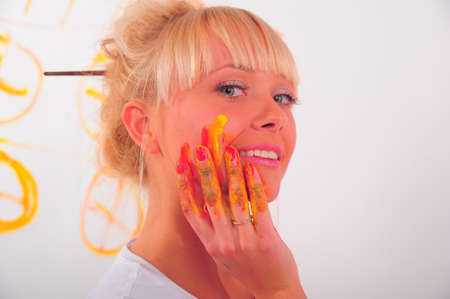 beautiful young woman and paintsの写真素材