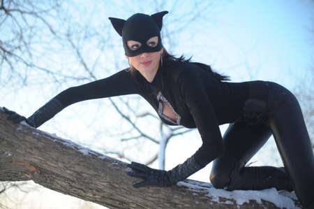 Beautiful young woman wearing  catsuit and maskの写真素材