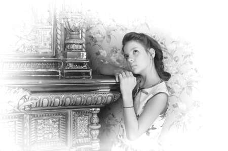 girl with retro hairdo about antique stoveの写真素材