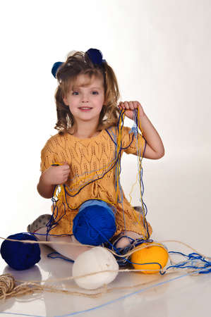 little girls play with balls of woolの写真素材