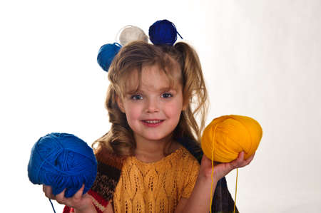 little girls play with balls of wool