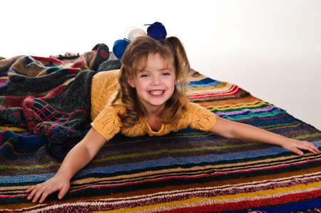 little girls play with balls of woolの写真素材