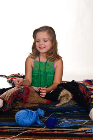 little girls play with balls of woolの写真素材