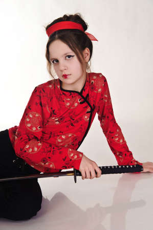 A girl handling a long samurai swordの写真素材