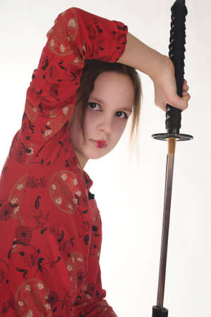 A girl handling a long samurai swordの写真素材