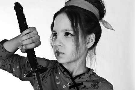 A girl handling a long samurai swordの写真素材