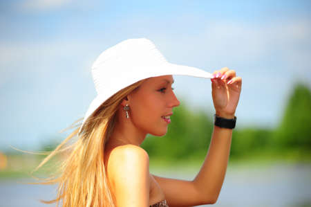 girl sitting on the shore of the lakeの写真素材