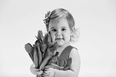little girl with a bouquet of yellow tulipsの写真素材