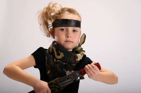 toddler girl with an army knifeの写真素材