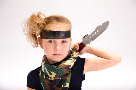 toddler girl with an army knifeの写真素材