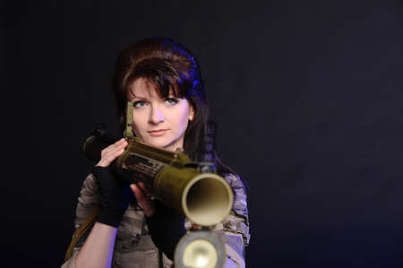 girl with a grenade launcher on a black background