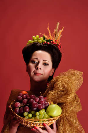 woman with a basket of fruitの写真素材