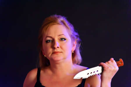 middle-aged woman with a knifeの写真素材