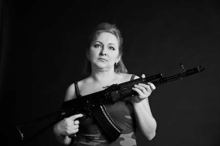 middle-aged woman with a gunの写真素材