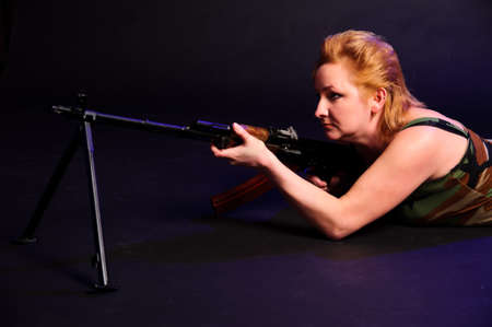 middle-aged woman with a gun