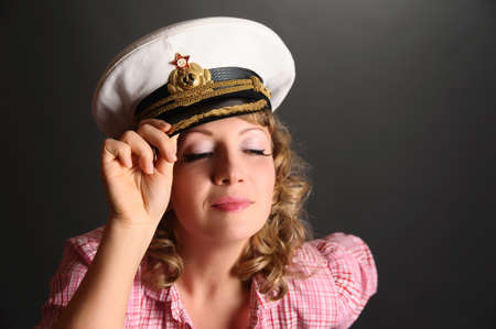 beautiful woman with a captain's capの写真素材