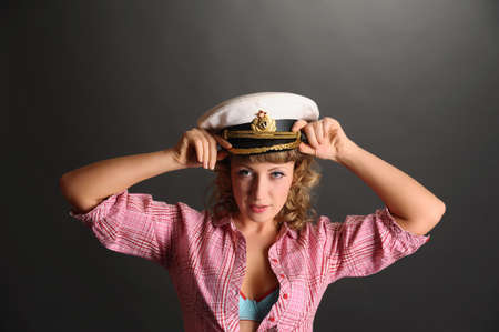 beautiful woman with a captain's capの写真素材