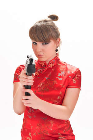 armed with a pistol girl in a red Chinese dressの写真素材