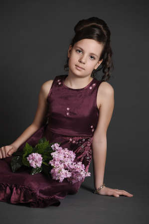 Girl with a branch of lilacの写真素材