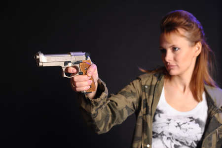 Portrait of the blonde with gunの写真素材