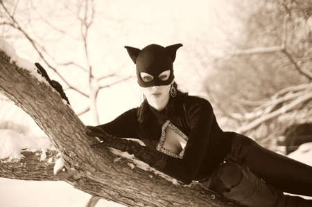 Beautiful young woman wearing catsuit and maskの写真素材