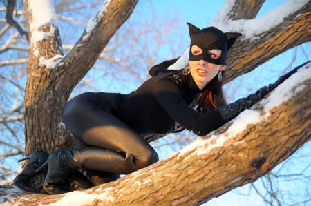 Beautiful young woman wearing catsuit and maskの写真素材