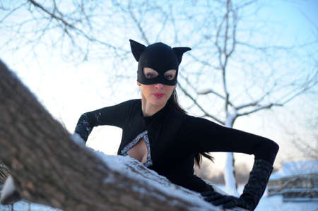 Beautiful young woman wearing catsuit and maskの写真素材