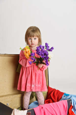 little girl and an old suitcaseの写真素材
