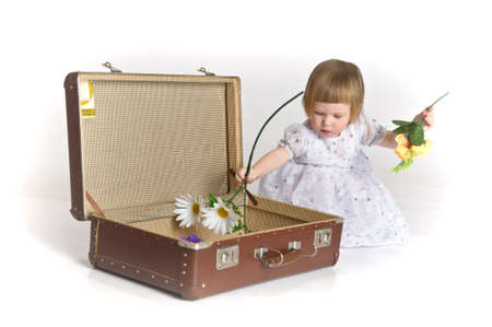 little girl and an old suitcaseの写真素材