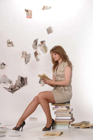 young woman next to a large Number of booksの写真素材