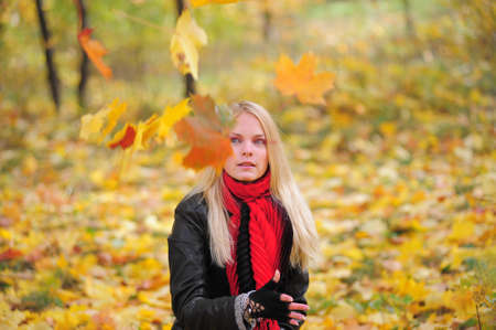beautiful young blond woman in autumn park