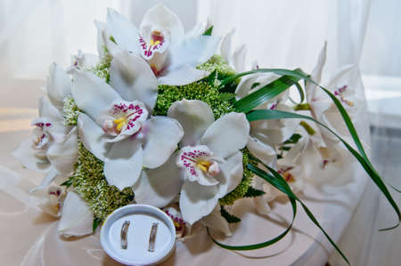 bouquet of orchids, and wedding ringsの写真素材