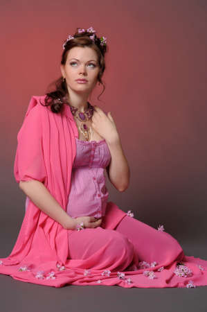 beautiful pregnant woman in the pinkの写真素材