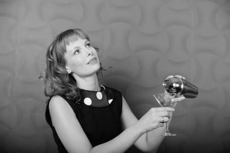 Vintage looking girl holding up shakerの写真素材