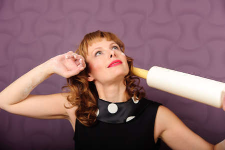 A woman prepares some dough for baking food.の写真素材