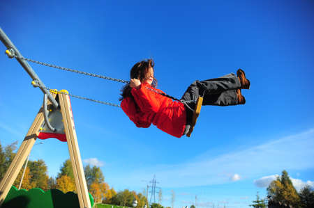 Girl swinging on a swing
