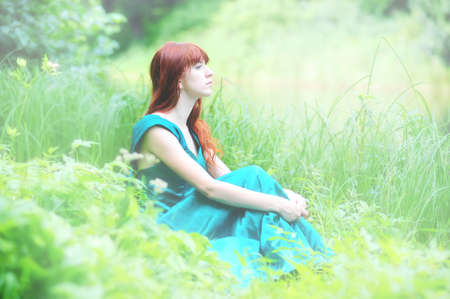 Girl in  dress on the green grassの写真素材