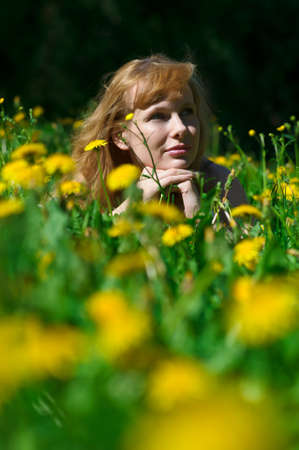 Nice girl  on the field of dandelionsの写真素材