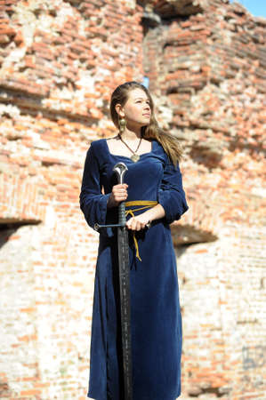 Young girl in medieval dress with  swordの写真素材