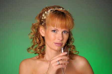 the bride with a glass of champagne in the studioの写真素材