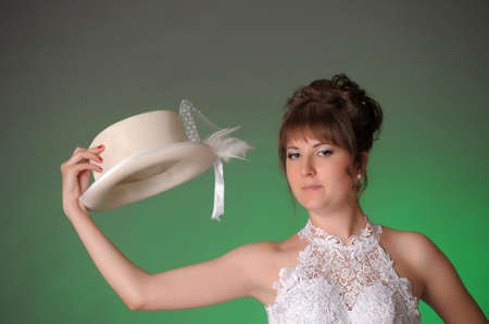 bride with white hat in his handの写真素材