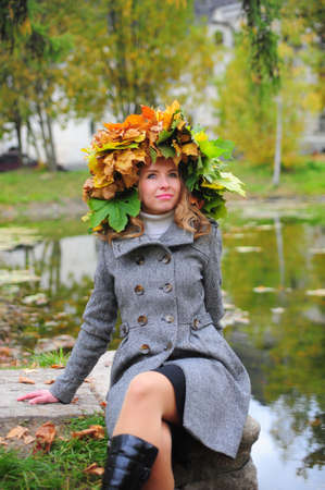 girl in a wreath of autumn leavesの写真素材