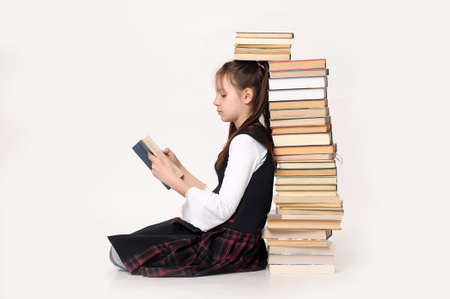 girl with a big stack of booksの写真素材