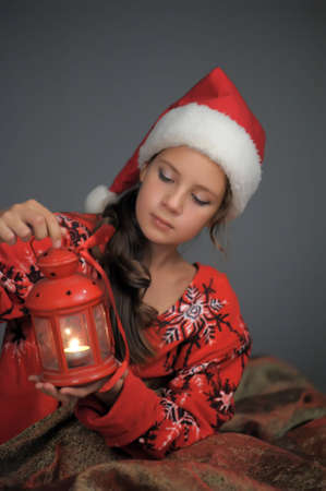 Girl in santa hat with Christmas lanternの写真素材