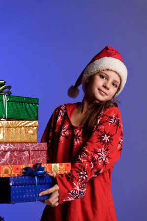Girl teenager in santa hat with Christmas giftsの写真素材