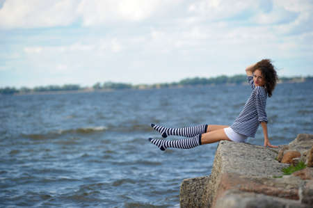 A young girl on the seashore, summer の写真素材