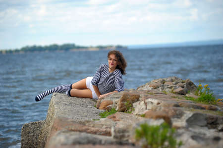 A young girl on the seashore, summer の写真素材