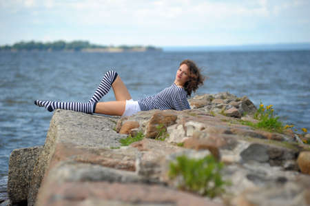A young girl on the seashore, summer の写真素材