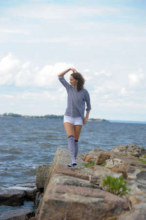 A young girl on the seashore, summer の写真素材